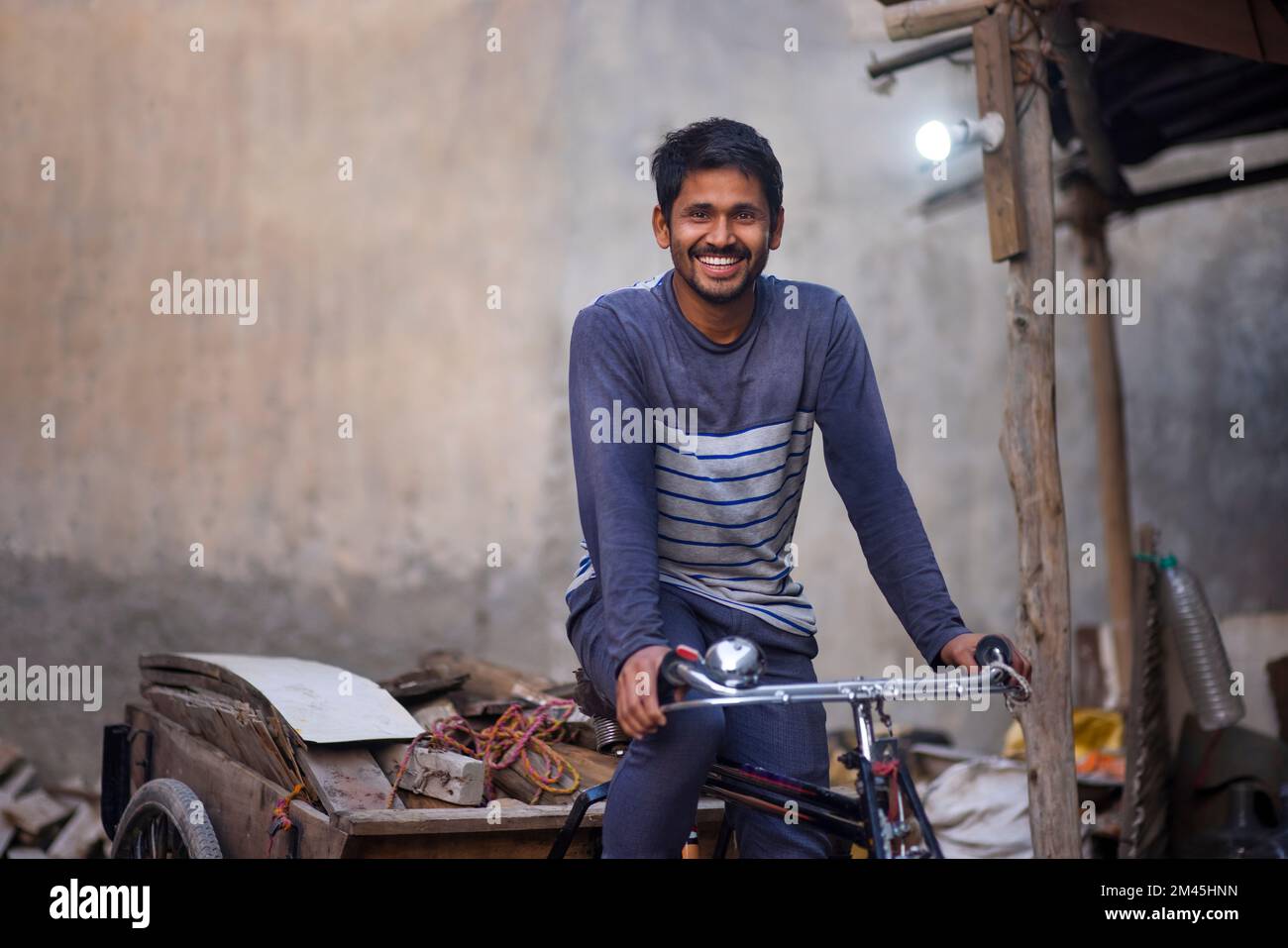 A Rickshaw puller taking away scrap Stock Photo - Alamy