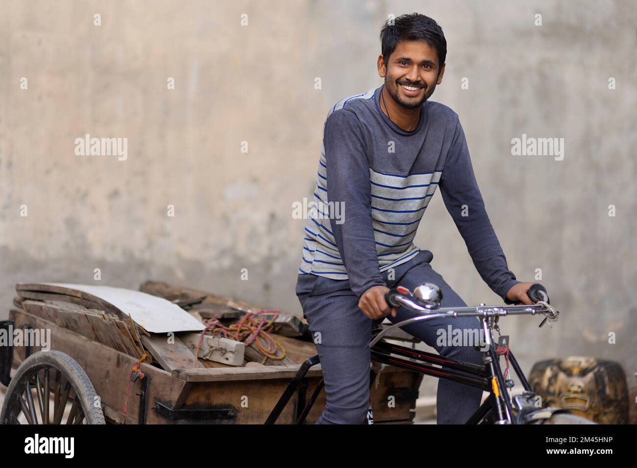 A Rickshaw puller taking away scrap Stock Photo - Alamy