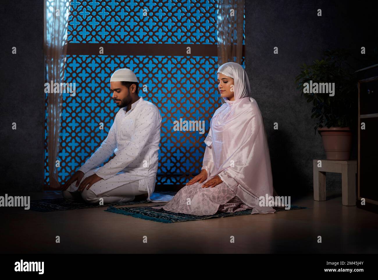 Portrait of Muslim Couple praying together at home Stock Photo Alamy