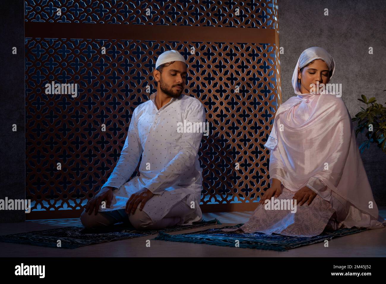 Portrait of Muslim Couple praying together at home Stock Photo Alamy