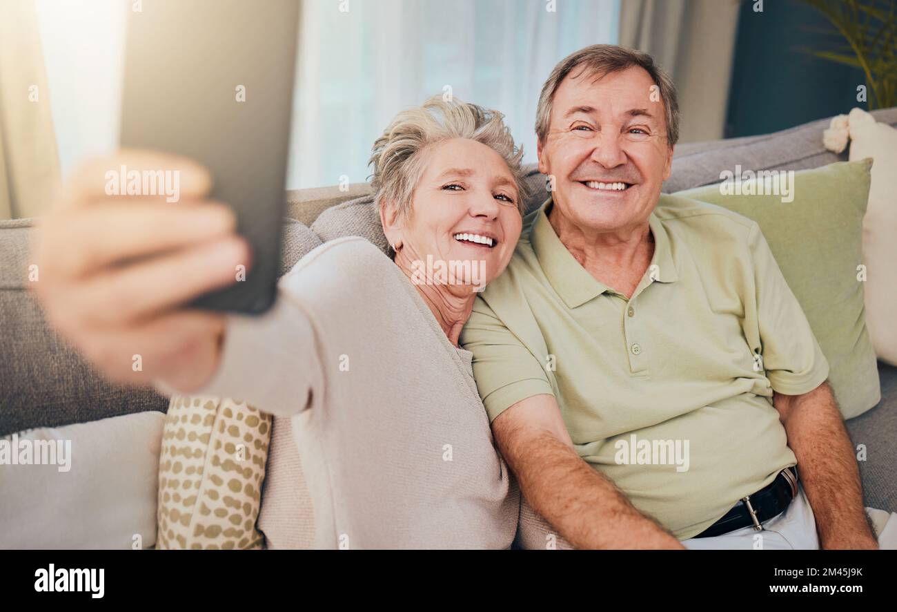 Senior selfie, crazy and couple with a phone for communication, smile and relax on the sofa during retirement. Mobile photo, funny and elderly man and Stock Photo