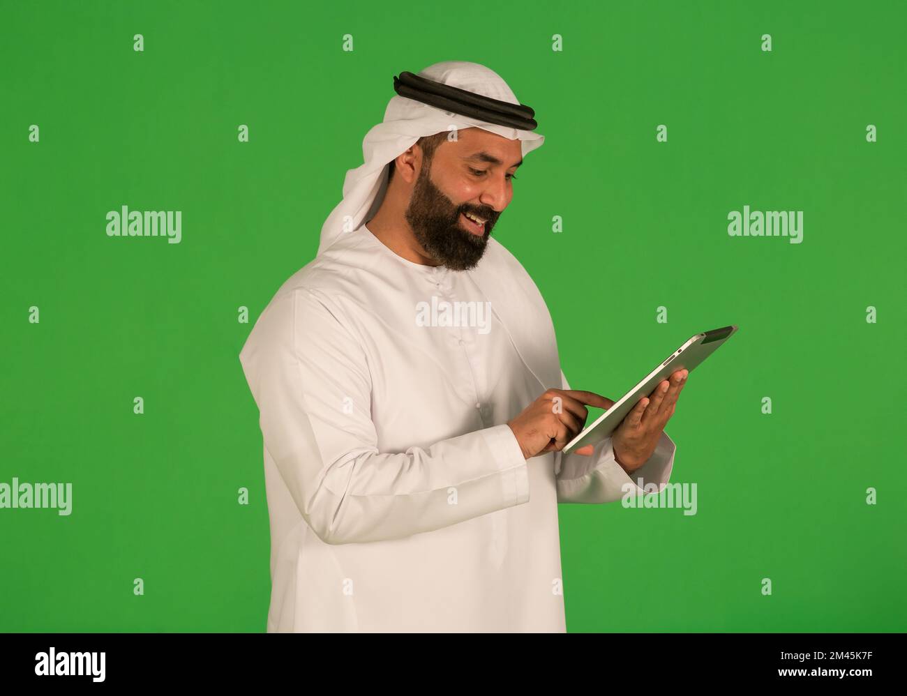 Emirati man using a digital tablet. Stock Photo
