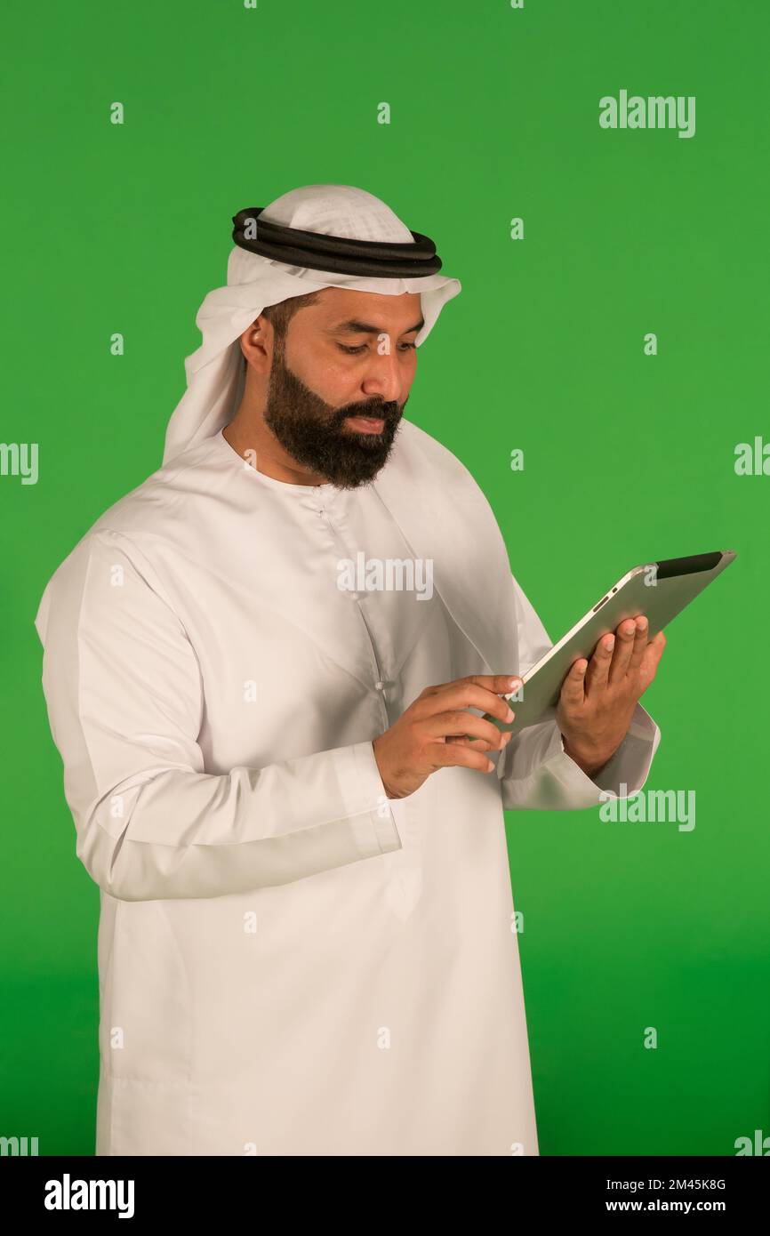 Emirati man using a digital tablet. Stock Photo