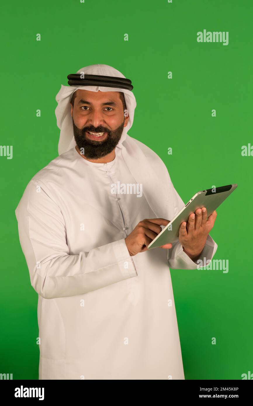 Emirati man using a digital tablet. Stock Photo