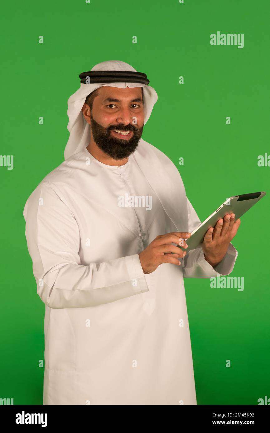 Emirati man using a digital tablet. Stock Photo