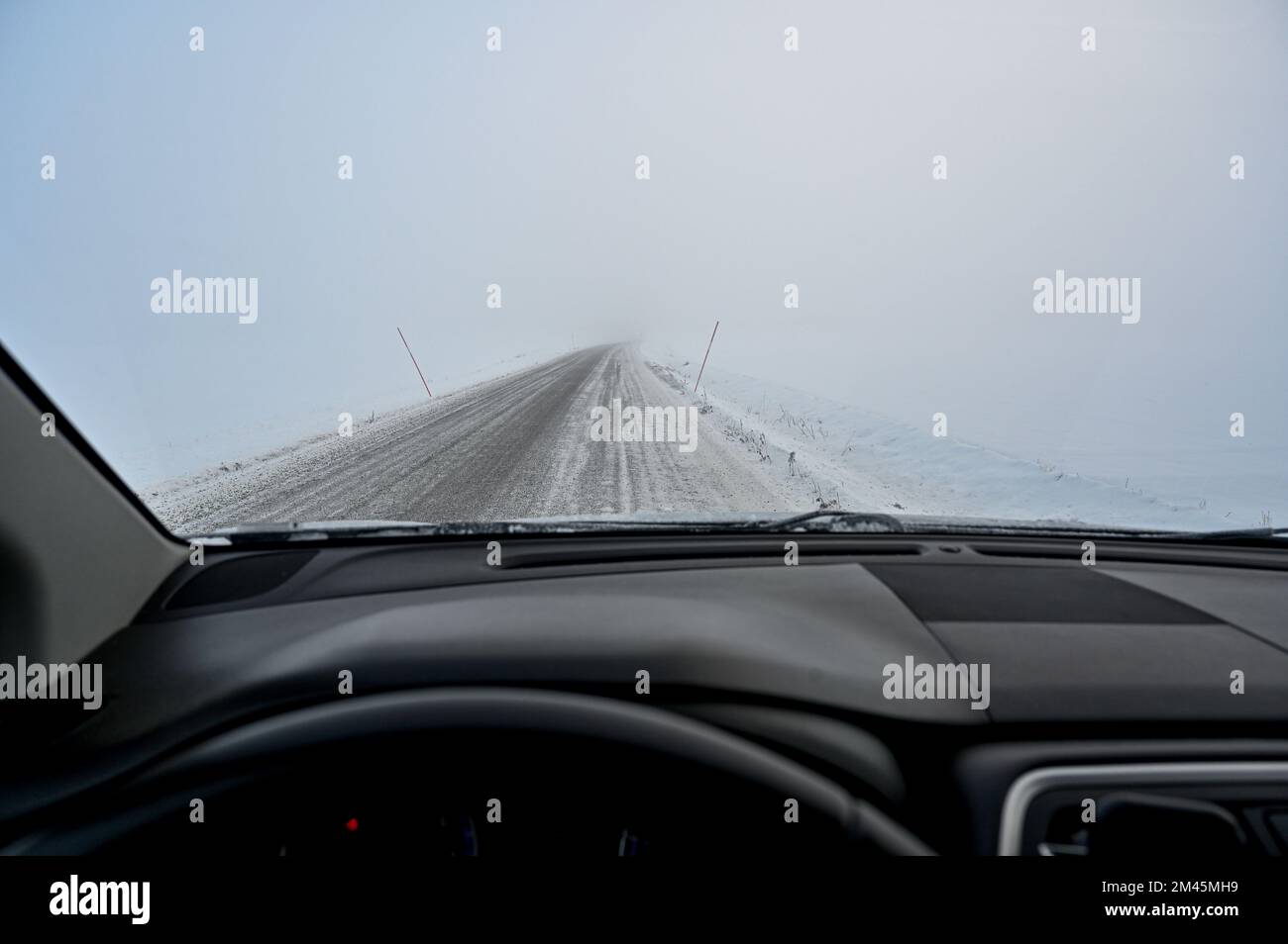 looking over steering wheel in to milky mist Stock Photo