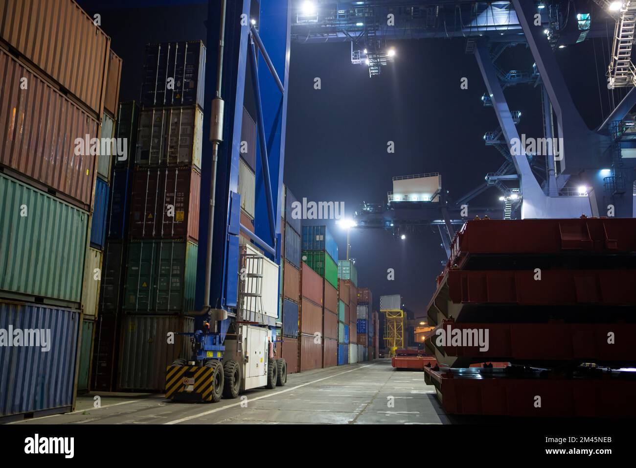 stacks of containers. operation of container terminal at night ...