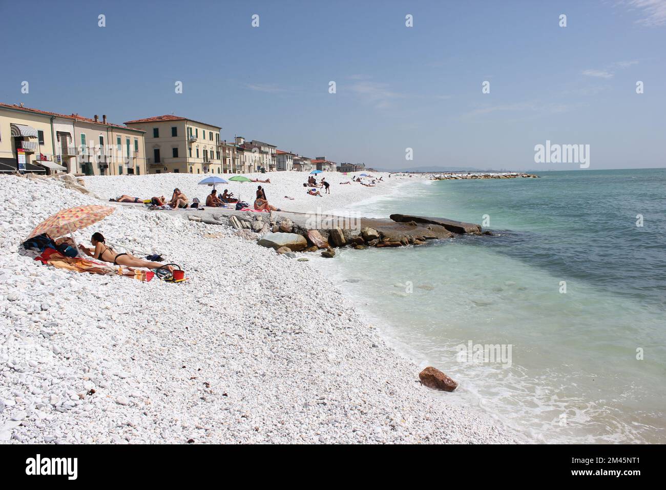 Italian Marina de Pisa shore, white marvel shiny pebble, sea, beach