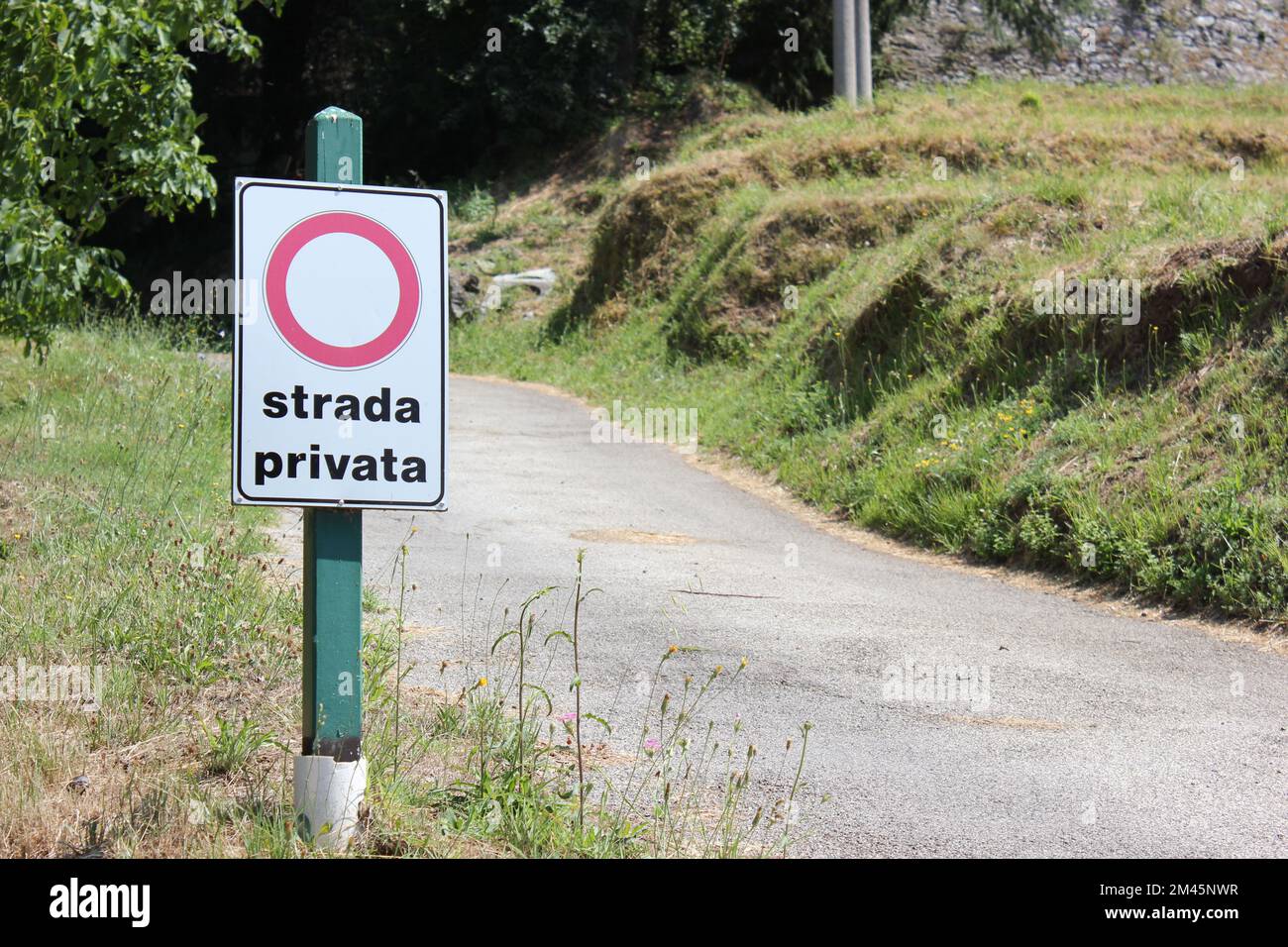 strada privata - Entrance to the private road in Tuscany, Italy, narrow road in summer Stock Photo