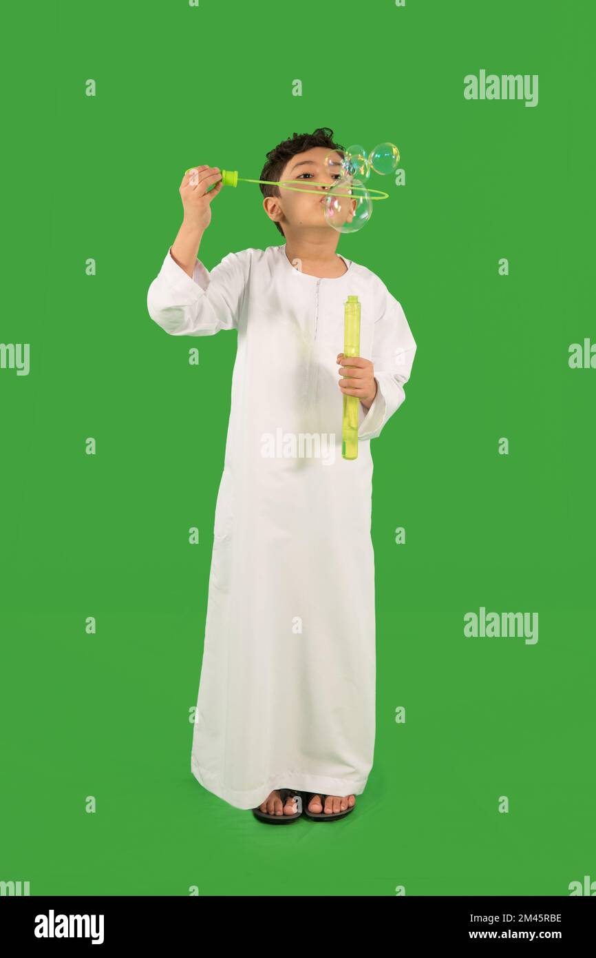 Arab boy blowing bubbles. Stock Photo