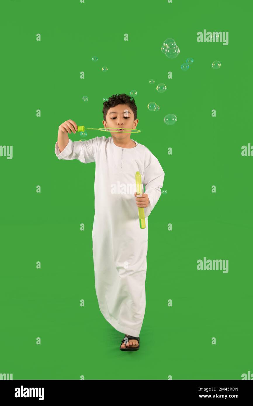 Arab boy blowing bubbles. Stock Photo