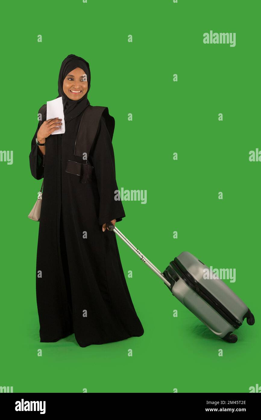Emirati woman carrying a suitcase Stock Photo