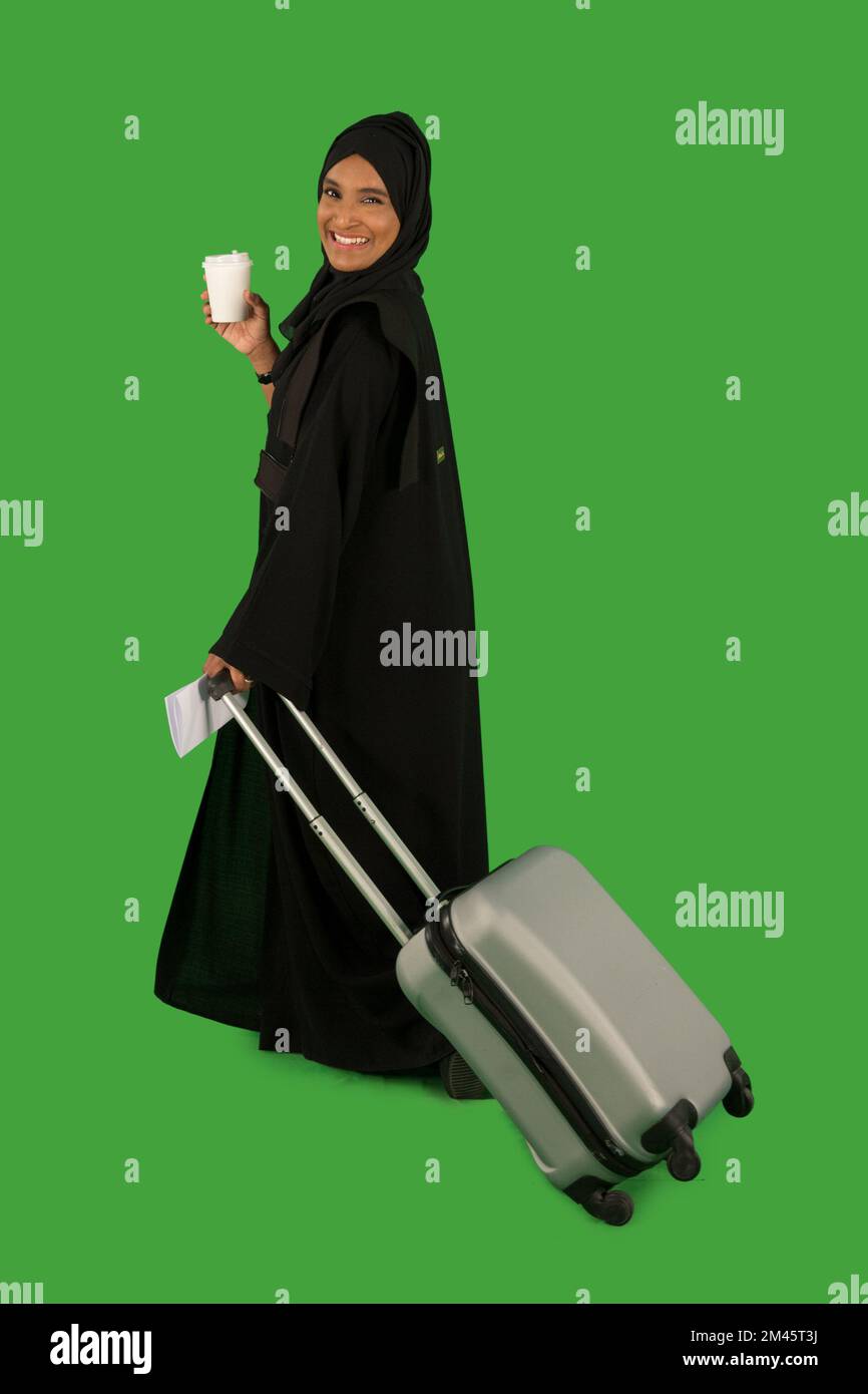 Emirati woman carrying a suitcase Stock Photo Alamy