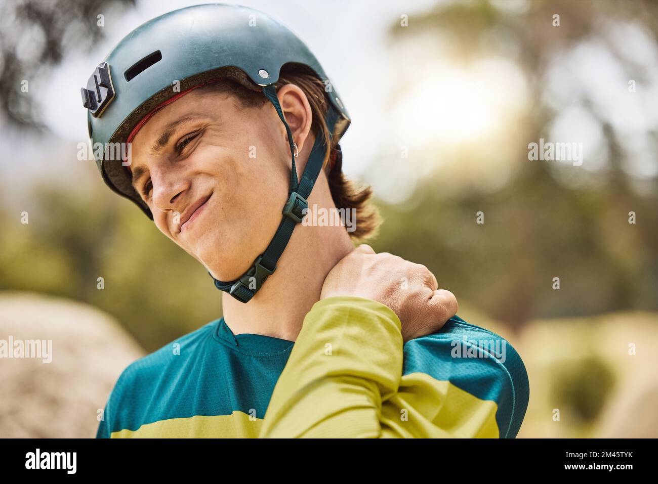 Man cyclist with shoulder pain, injury or accident from sports training for a cycling race or marathon. Fitness, exercise and male athlete with a Stock Photo