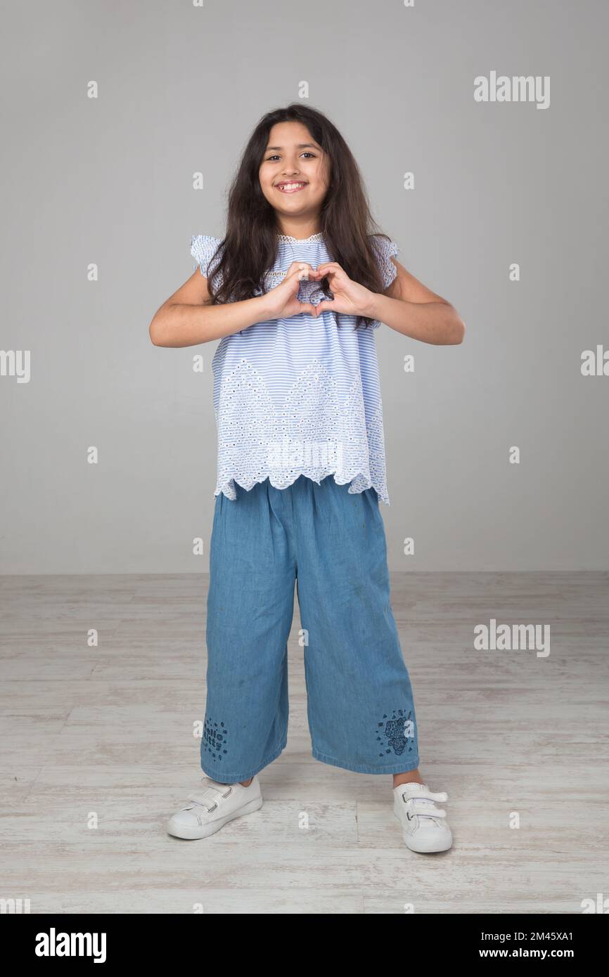 Portrait of a young arab girl doing a hand sign. Stock Photo