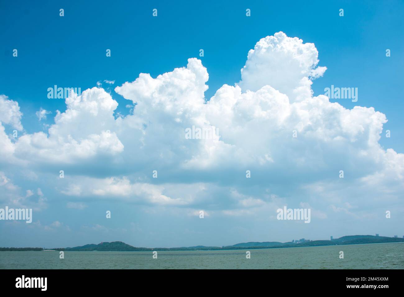 A landscape of the sea with white clouds in the blue sky Stock Photo ...