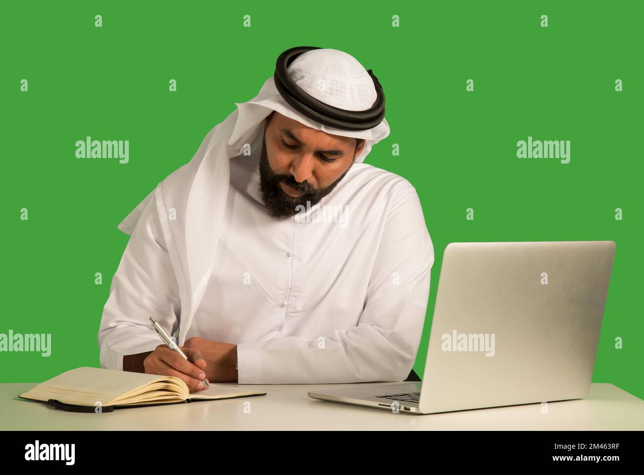 Emirati man working on a laptop. Stock Photo