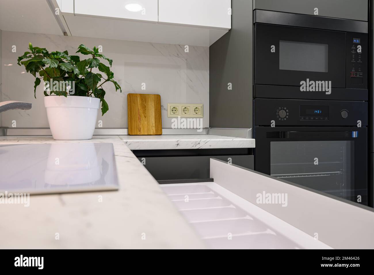 Marble worktop of modern white and dark grey kitchen Stock Photo Alamy