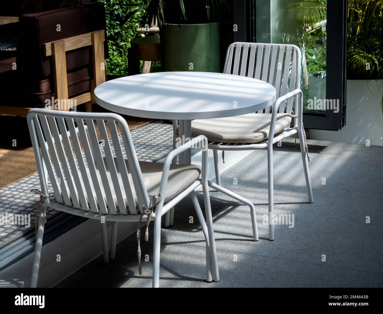 Outdoor small table set at the restaurant or cafe two empty chairs
