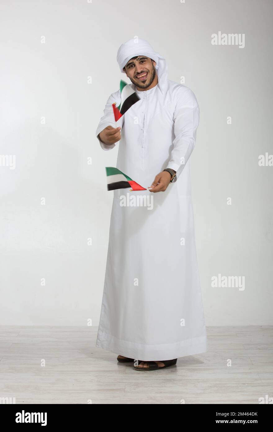 Emirati man holding the UAE national flag Stock Photo Alamy