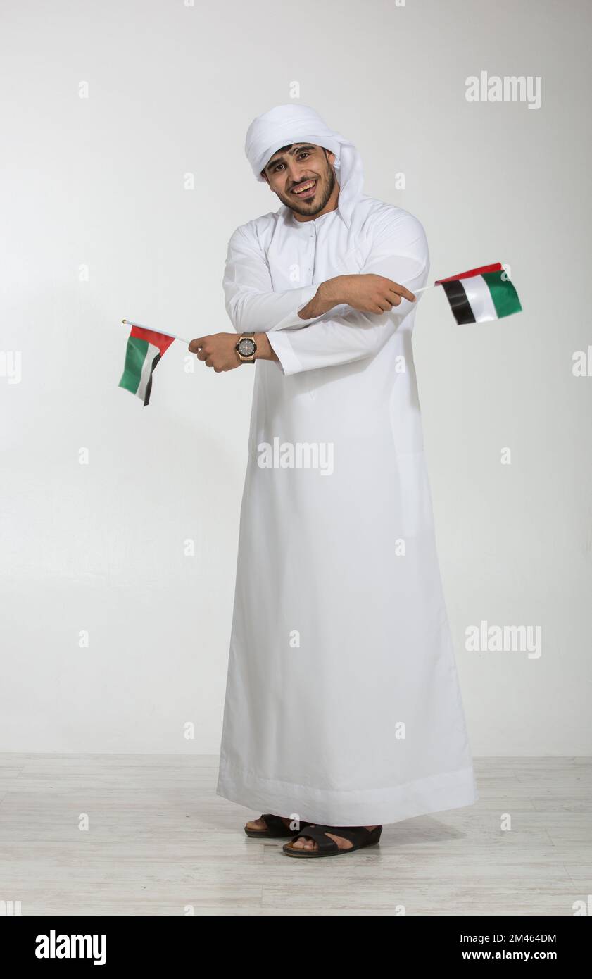 Emirati man holding the UAE national flag Stock Photo Alamy