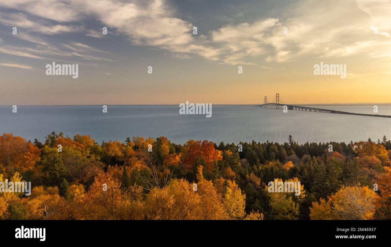 An aerial view of sea surrounded by autumn trees during sunset Stock ...
