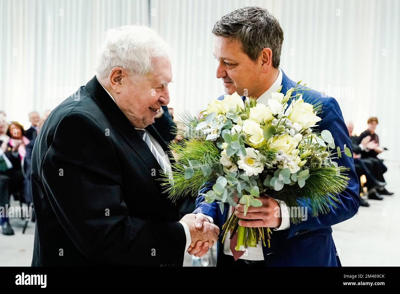 Speyer, Germany. 19th Dec, 2022. Bernhard Vogel (l, CDU), former prime minister of Rhineland-Palatinate and Thuringia, is presented with a bouquet of flowers by Christian Baldauf, CDU chairman of Rhineland-Palatinate, at his 90th birthday celebration at the Technik Museum Speyer. Bernhard Vogel was the only prime minister ever to govern a state in both West and East Germany. He was head of government in Rhineland-Palatinate from 1976 to 1988 and governed in Thuringia from 1992 to 2003. Credit: Uwe Anspach/dpa/Alamy Live News Stock Photo