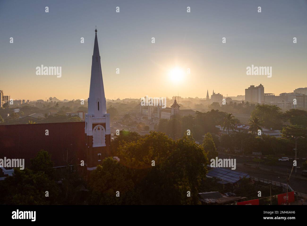 Sun rising over central Yangon, Myanmar, and the Yangon Central Railway Station. Stock Photo