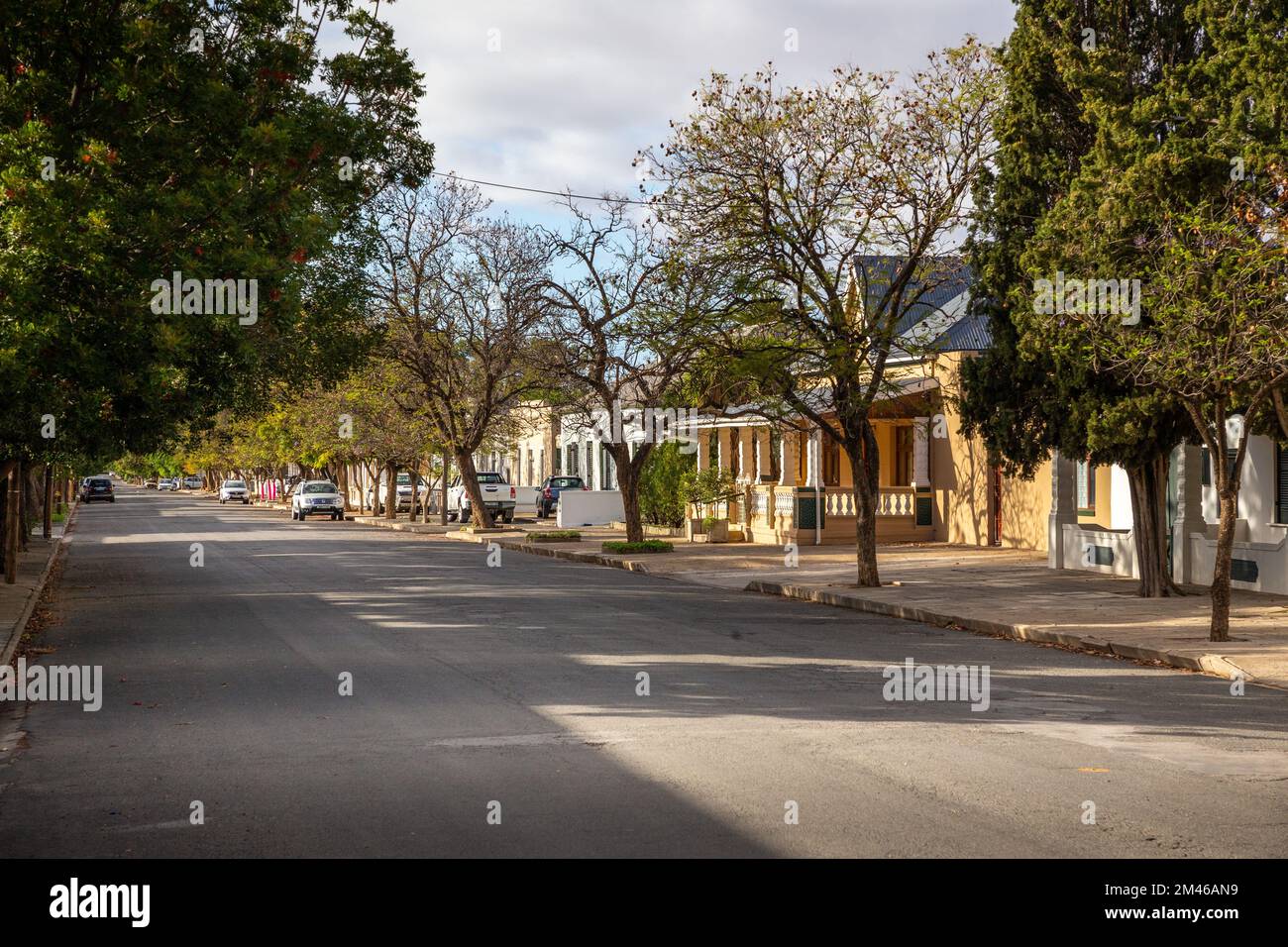 Traditional colonial style houses line a suburban street in Graaff