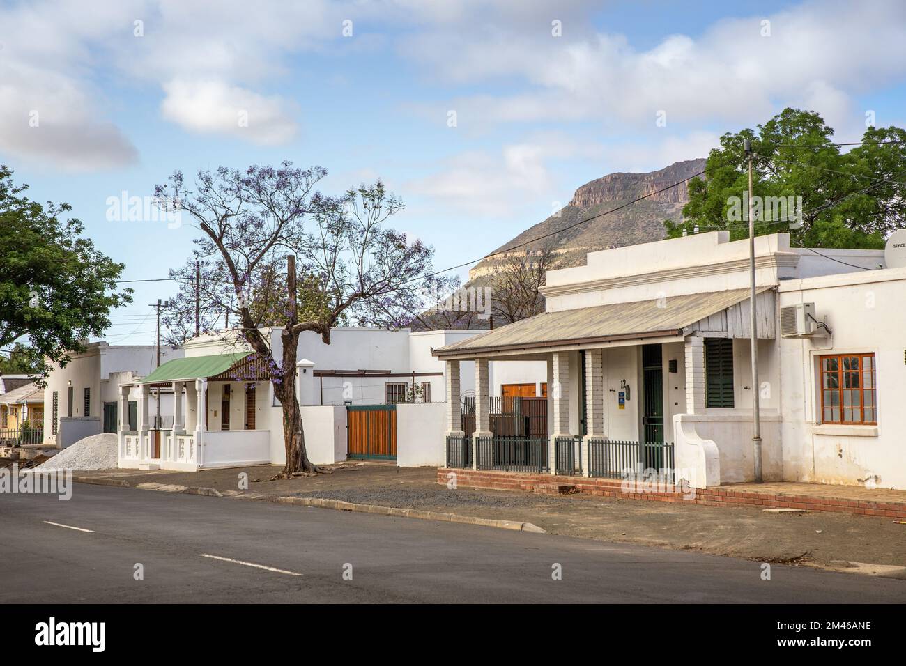 Traditional colonial style houses line a suburban street in Graaff