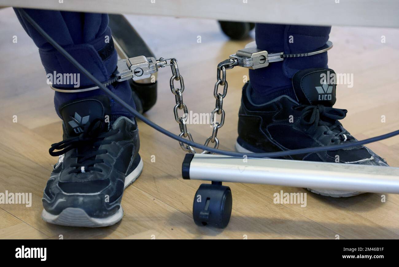 Rostock, Germany. 19th Dec, 2022. The defendant in the triple murder trial sits in the courtroom with an ankle bracelet. The 27-year-old man allegedly murdered his parents and sister. Credit: Bernd Wüstneck/dpa/Alamy Live News Stock Photo