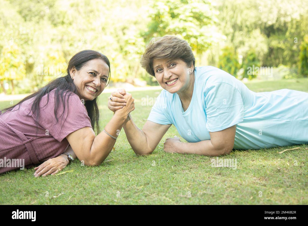 Senior Indian women Arm Wrestling Game With Each Other At Park Outdoor