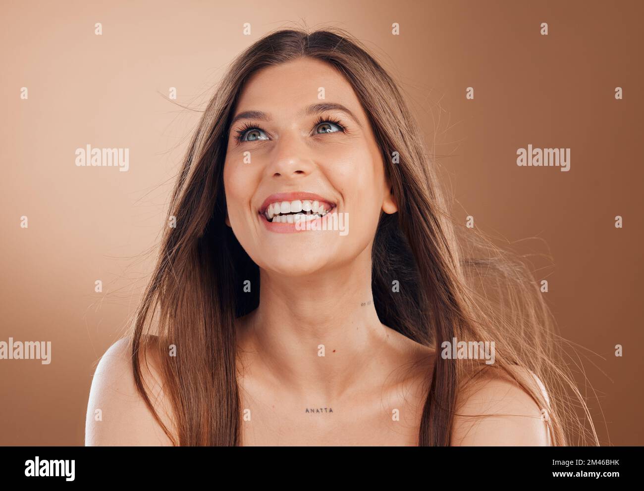 Hair, beauty and face of woman with smile on brown background for wellness, skincare and luxury spa. Cosmetics, health and happy girl with blowing Stock Photo