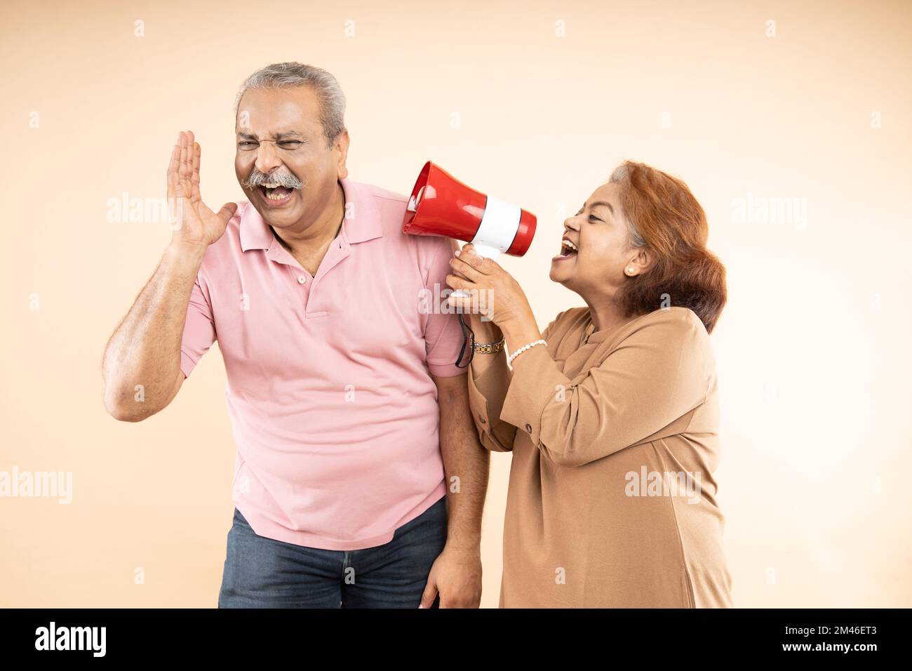 Senior Indian Woman Scream Or Shouting At Man In Megaphone Isolated On