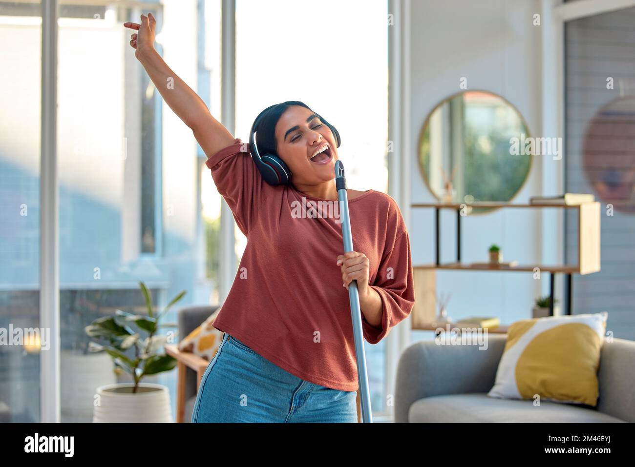 Cleaning, singing and woman dance to music for fun, energy and