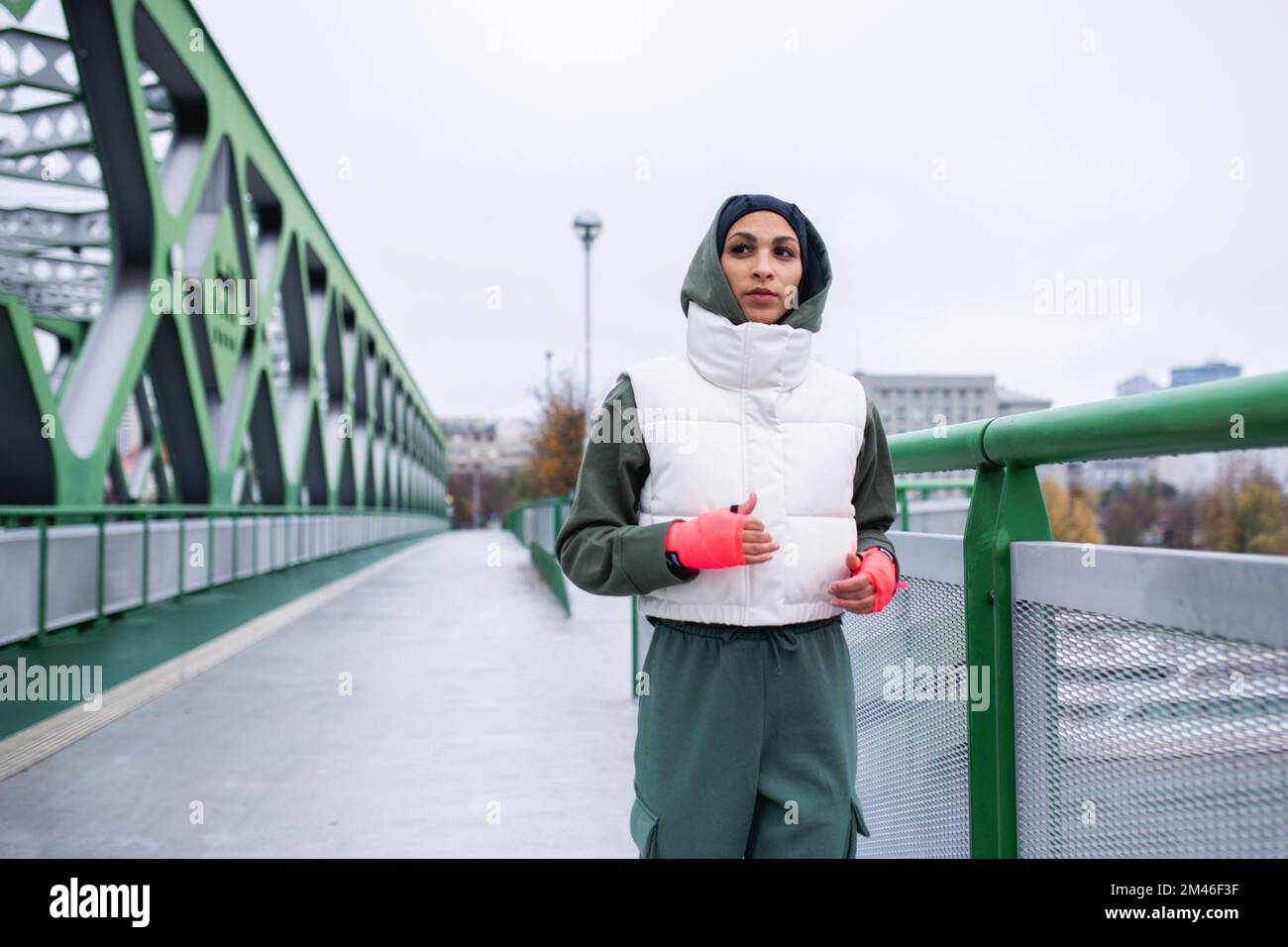 Young muslim woman running outdoor in city. Stock Photo