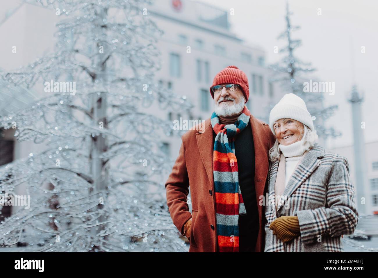 Senior couple walking in winter city center. Stock Photo