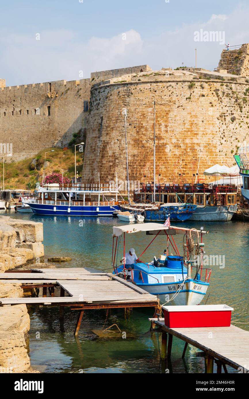 Fisherman in traditional Cypriot fishing boat in Kyrenia, Girne, Harbour beneath the walls of the castle.Turkish Republic of Northern Cyprus. Stock Photo