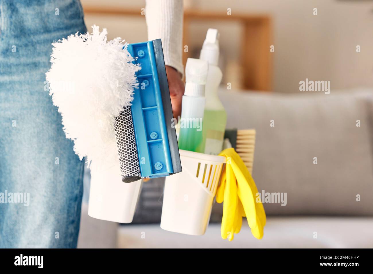 Cleaning, products and hand of cleaner with basket in home preparing for cleaning service. Spring cleaning, hygiene and black woman with cleaning Stock Photo