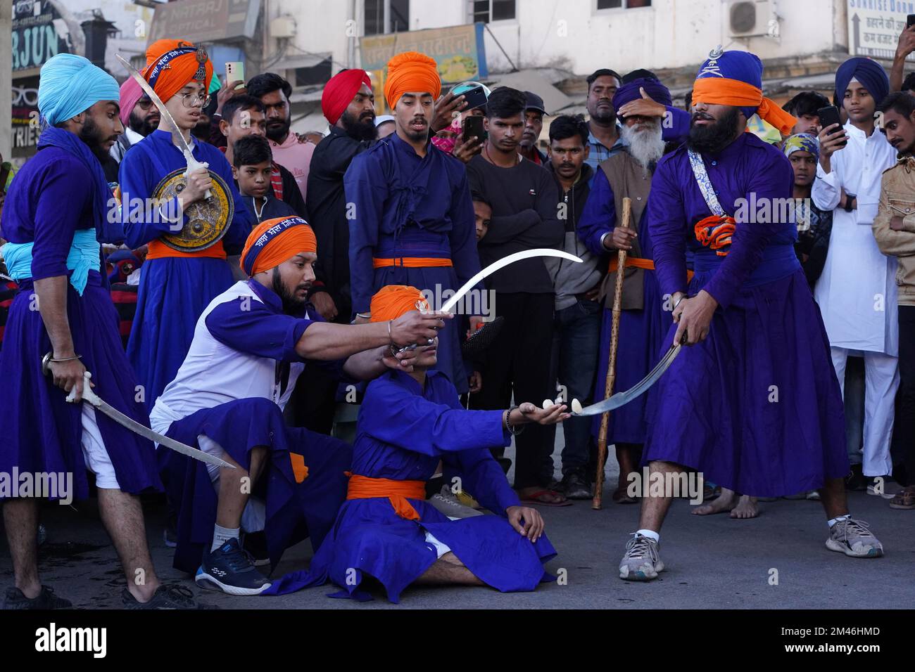 Indian Sikh demonstrates his traditional martial art skills during the 'Nagar Kirtan' procession