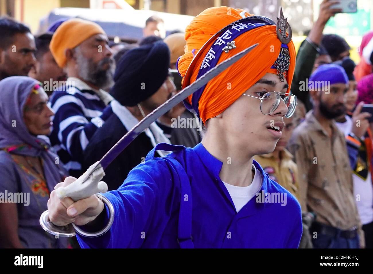Indian Sikh demonstrates his traditional martial art skills during the 'Nagar Kirtan' procession