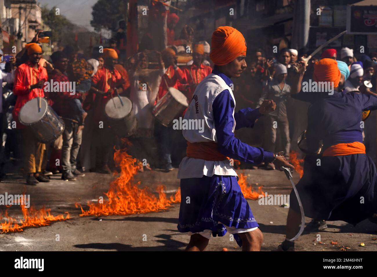 Indian Sikh demonstrates his traditional martial art skills during the 'Nagar Kirtan' procession