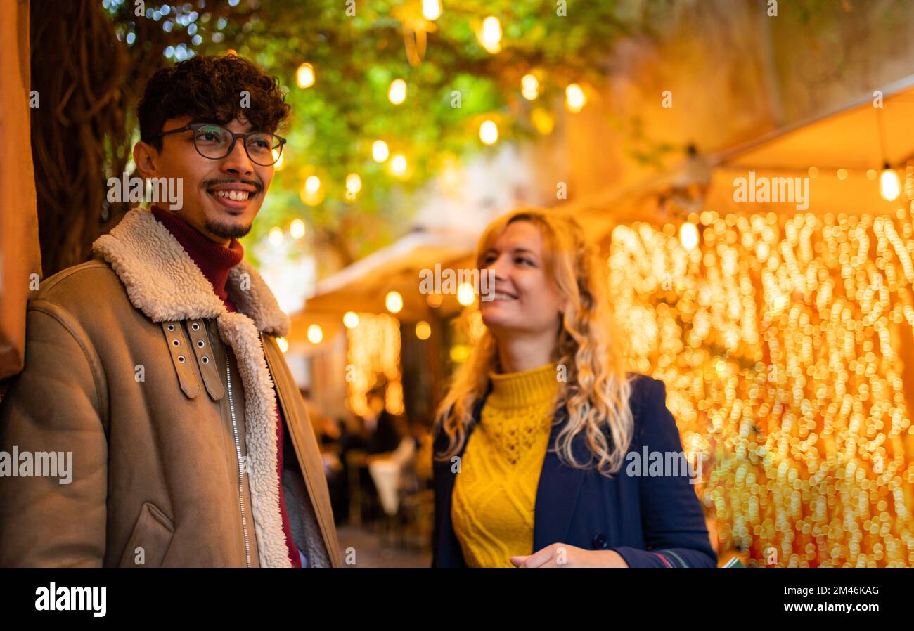 selective focus on arab young man smiling While talking with his girlfriend Stock Photo