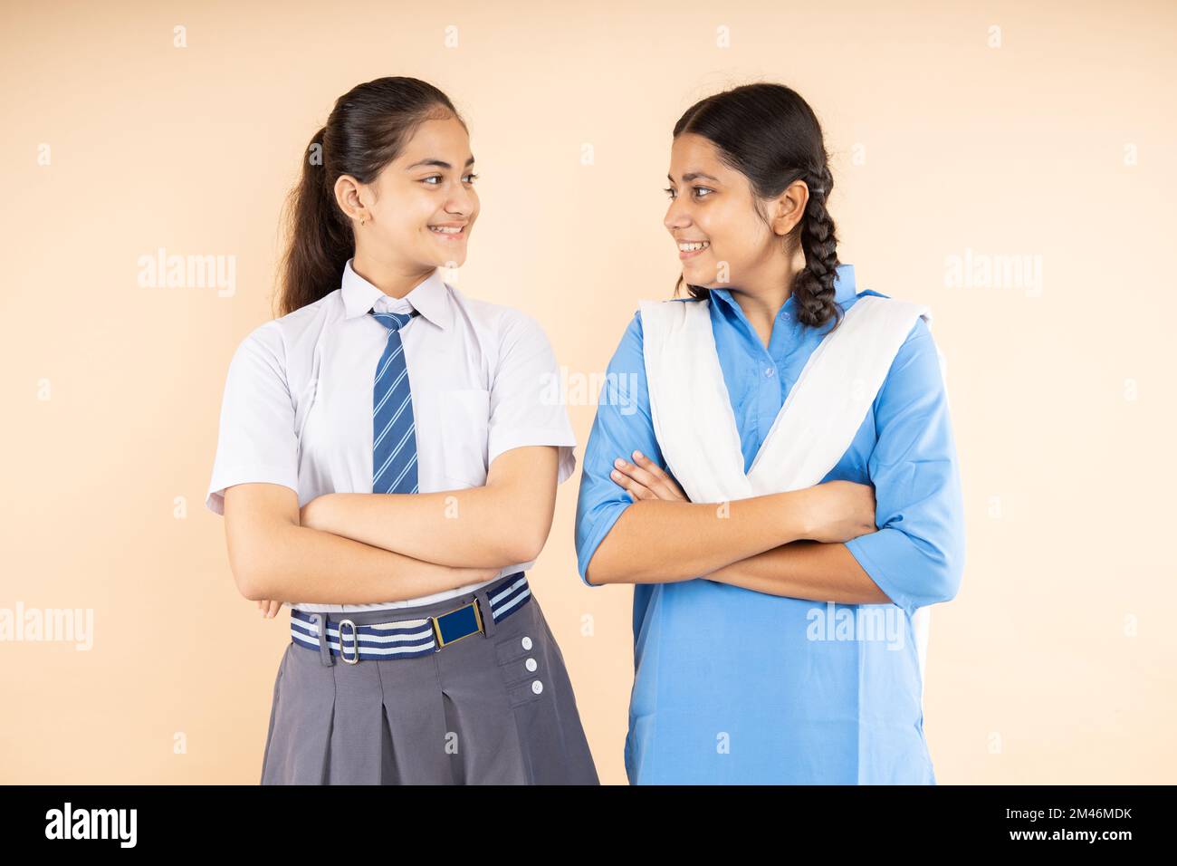 Happy Rural and Modern Indian student schoolgirls wearing school