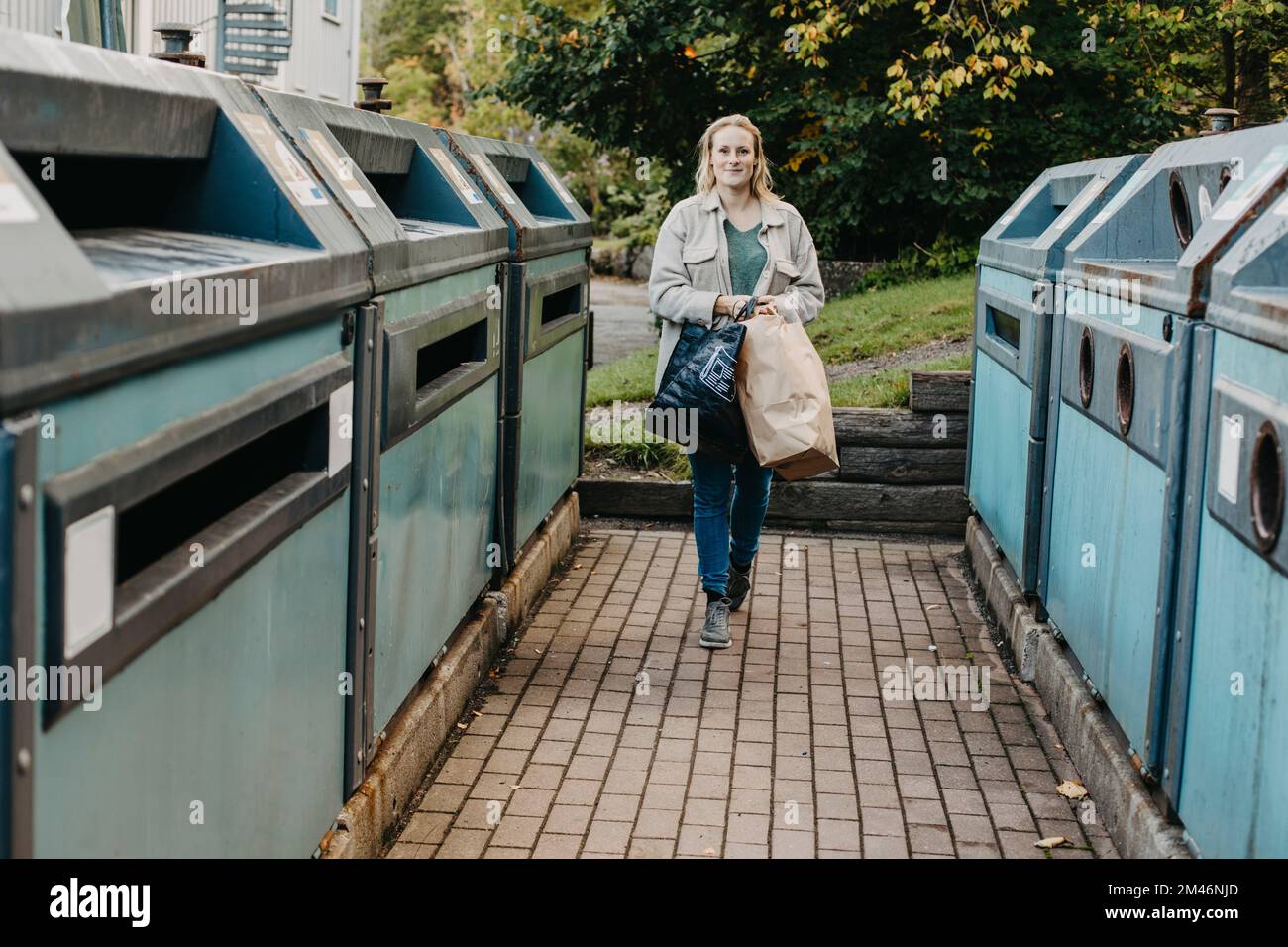 Woman carrying garbage bag hires stock photography and images Alamy