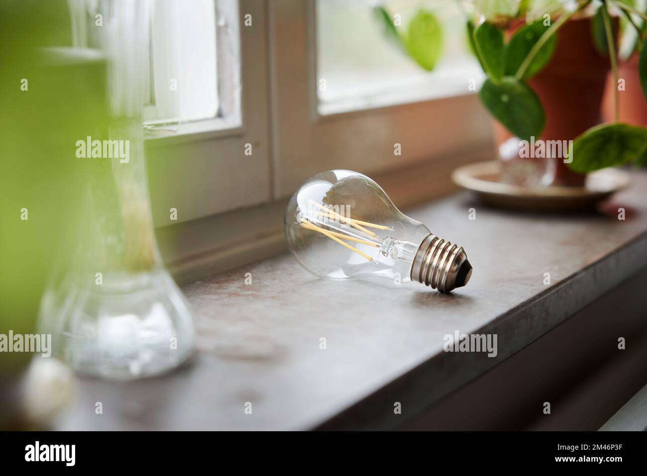 Light bulb on windowsill Stock Photo