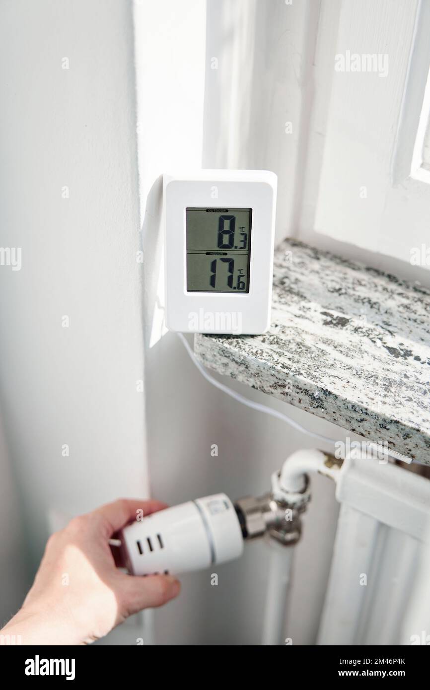 Hand adjusting temperature control in radiator Stock Photo Alamy