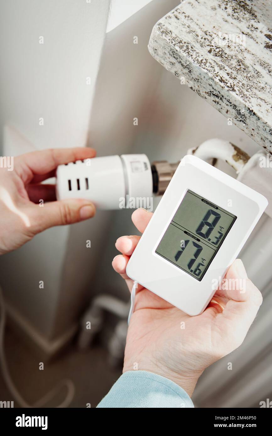 Hand adjusting temperature control in radiator Stock Photo Alamy