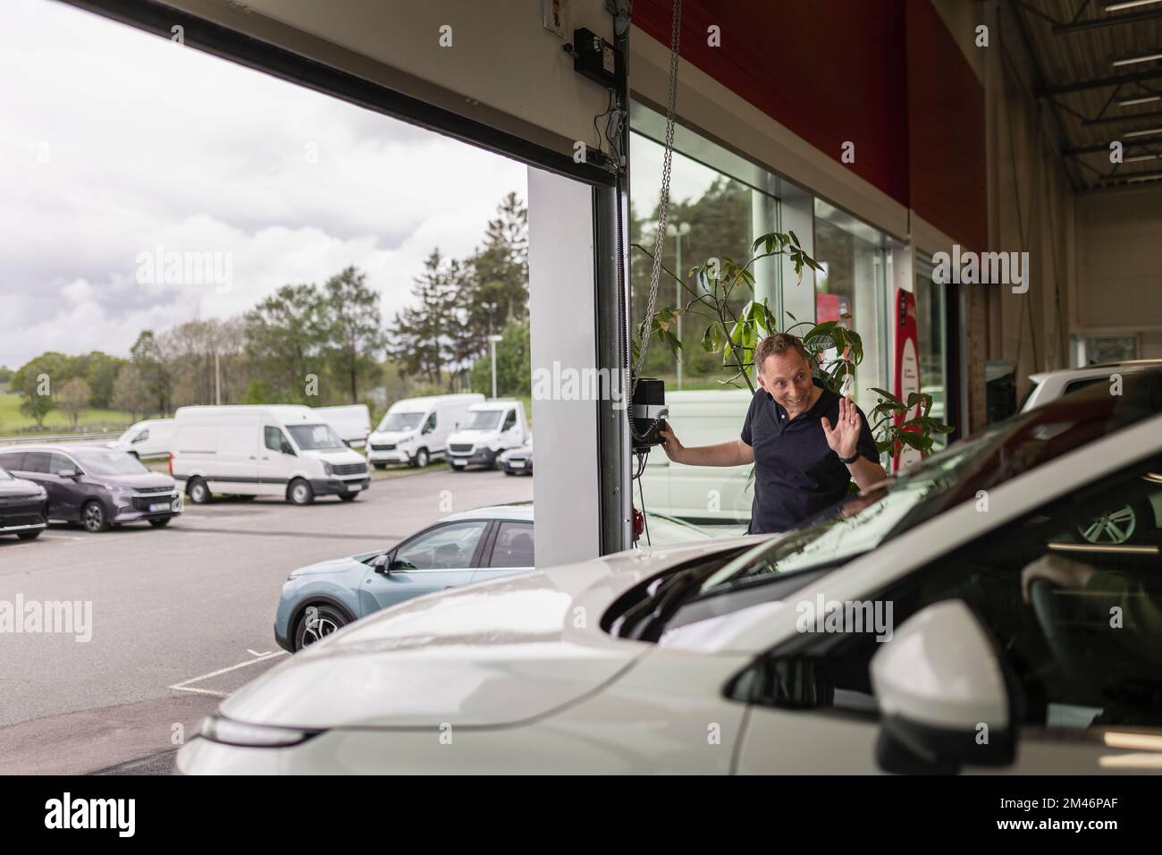 Customer leaving car dealership office Stock Photo Alamy