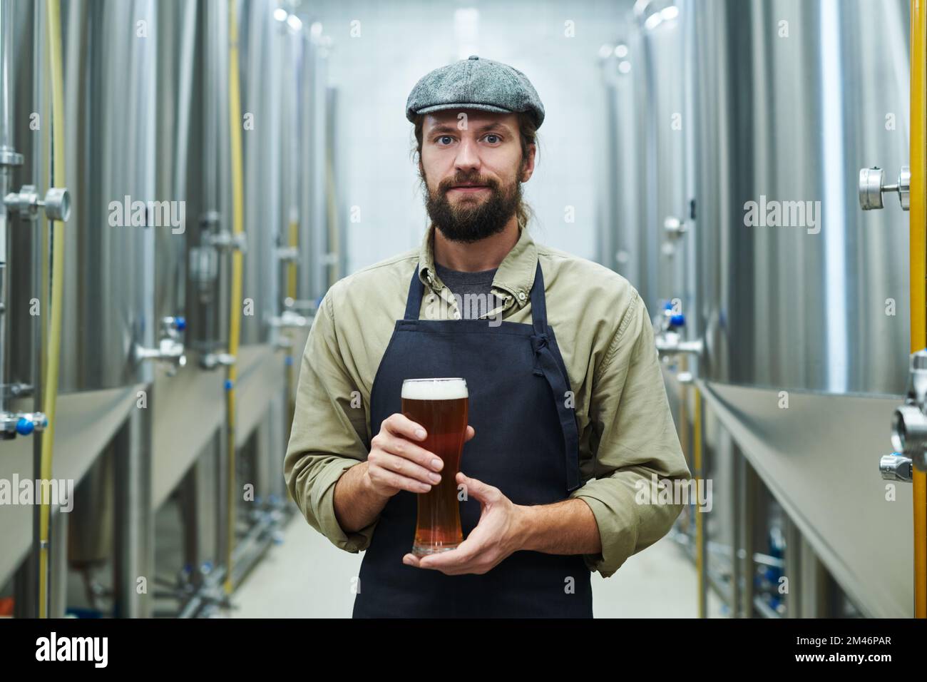Portrait of brewery manager holding big glass of beer Stock Photo Alamy